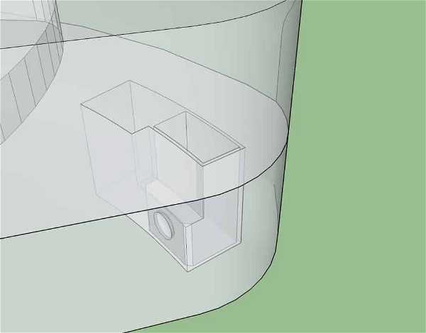 A 3D model illustration showing a partially transparent cylindrical structure with an enclosed rectangular compartment. The rectangular compartment includes a protruding circular element on one side. The background is green, suggesting a grass or landscape setting.