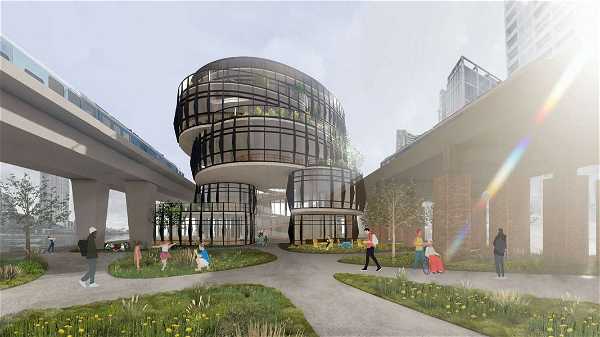 Modern architectural design featuring a cylindrical, multi-level glass building surrounded by paths and greenery. Elevated train tracks and tall urban structures are in the background, with people walking and interacting in the foreground.
